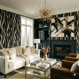 Abstract wave wallpaper with black, white, and gold pattern, styled in a modern living room.
