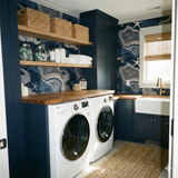 Bathymetric Starshore Wallpaper with a swirling design with blue and grey accents, styled with starfish pattern in a laundry room.