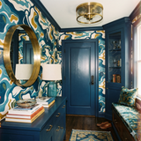 Estuarine Drift Wallpaper featuring an abstract organic pattern, including white, blue, and gold hues.
