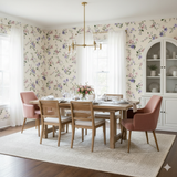 Floral Briar Lane Wallpaper from York Wallcoverings, patterned with pastel purple and pink blossoms on an off-white background in a styled dining room.
