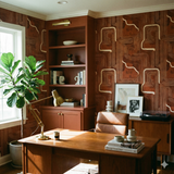 Geometric patterned wallpaper by Hygge & West, featuring mid-century modern shapes and a warm brown color palette.
