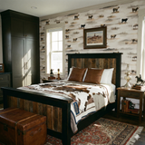 Open Range Quiet Wallpaper with cow pattern covering bedroom walls, styled with rustic wood furnishings.