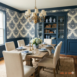 Navy wallpaper with a filigree pattern, featuring damask-style medallions, decorates a dining room with blue wainscoting.

