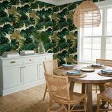 Patterned Emerald Foundry Wallpaper with monstera leaf design on a textured neutral background.