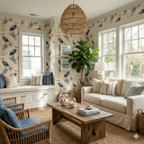 Patterned Cypress Watch Wallpaper with blue herons and watery reflections, covering the walls of a living room.