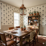 Patterned wallpaper with windmill print, and cactus plants atop a hutch, in a dining room setting.
