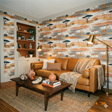 Savanna Meridian Wallpaper with giraffe and elephant pattern on an abstract earth tone backdrop.
