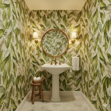 Evergreen Chapel Wallpaper with a green leaf pattern, decorating a powder room.
