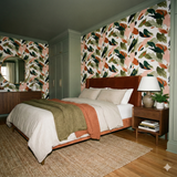 Verdance Etude Wallpaper featuring a leafy, painterly pattern with green, white, and blush tones.