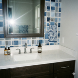 Blue block wallpaper by Brewster, with gray grout lines, visible in a bathroom setting.