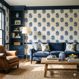 Cobalt Herbarium Press wallpaper with a floral pattern against a white background, decorating a room with a blue sofa and brown armchair.