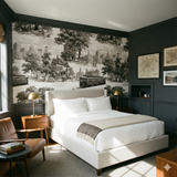 Queen’s Crossing Carriageway Wallpaper featuring black and white city-inspired toile pattern on a bedroom wall.
