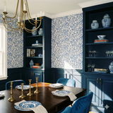Meadowvine Wallpaper with blue leafy pattern on a light beige background.
