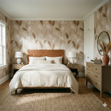 Sundrift Pampas Wallpaper with neutral brown and beige shades, featuring a feather motif, and applied to a bedroom wall.