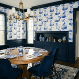 Cloudborne Persians Wallpaper with blue cat pattern, from York Wallcoverings, set in a blue paneled dining room.
