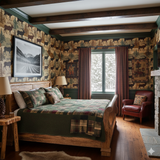 Elkford Range wallpaper featuring elk and pine tree patterns, on the wall of a rustic bedroom.

