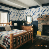 Howlcrest Ridge Wallpaper with blue wolf print from Howlcrest, decorating a bedroom with wood accents.