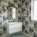 Mariner’s Field wallpaper with a repeating dog portrait pattern, installed in a bathroom with a white vanity.
