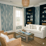 Blue and white patterned wallpaper by Seabrook Wallcoverings with vertical bands, in a styled room with neutral decor.