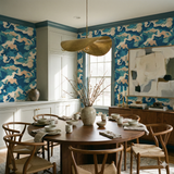 Caspian Sink Wallpaper with a camouflage pattern in blue and beige tones, covering the walls of a dining room.