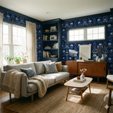 Floral print wallpaper with blue backdrop, by Boråstapeter, covering the walls around the windows and a shelving unit.