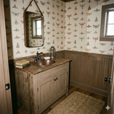 Insect patterned wallpaper with beige background and light brown wood paneling.