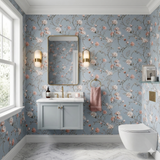 Floral Primavera Celeste Wallpaper with a blue background, featuring peach and white blossoms.