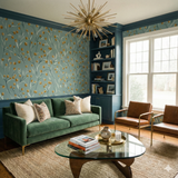 Botanical wallpaper with gold accents on a light blue background, featuring a stem pattern and texture.