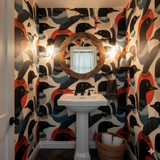 Colorful bird patterned wallpaper with black accents and pops of red.