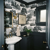 Queen’s Crossing Carriageway wallpaper with a black and white toile pattern, featuring historical cityscapes.
