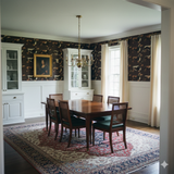 Brown patterned Brindle & Bourbon Wallpaper with an equestrian style design, covering the upper part of a traditional dining room.