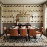 Harlow Parade wallpaper with rows of animal illustrations, above gray wainscoting in a dining room.
