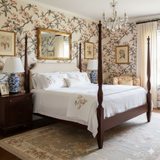 Floral Ink Bloom Camellia Wallpaper with a blossom design, covering the bedroom walls.