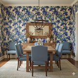 Floral irises wallpaper with blue flowers on beige, covering the walls in a dining room.