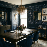 Blue and gray patterned wallpaper with navy trim, featuring a leopard print design.
