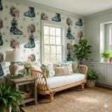 Wrenfield Daisie Wallpaper with a floral girl pattern, covering a room with a window and a sofa.
