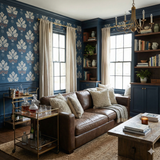 Patterned wallpaper with floral motif in blue, white, and brown, styled in a living room.
