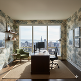 Savanna Storyline wallpaper with a tree and animal pattern, covering the walls of a room with a large window and brown desk.
