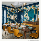 Estuarine Drift wallpaper with blue, white and gold abstract pattern, styled in a dining room setting.
