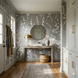 Grey floral wallpaper with blossom branches, cascading by Silverling Bloom, in a hallway setting.
