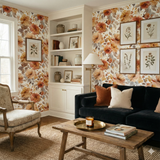 Floral Septembre Blush Wallpaper with golden-orange blooms, against a muted floral backdrop.