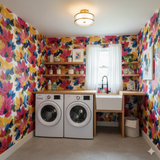 Floral bloom wallpaper with yellow, blue, and pink brushstrokes, in a laundry room.