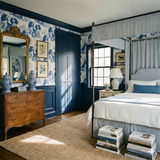 Kingsley Spaniel Wallpaper with a dog pattern, decorating a bedroom with navy blue trim and a brown woven rug.