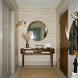 Briarline Ticking Wallpaper with brown stripes over white background, decorating a hallway with furniture.