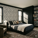 Inkline Carousel wallpaper with black swirling line design, seen on a bedroom wall.