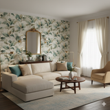Eucalyptus Vale wallpaper with green and white leaf pattern, against a living room setting.
