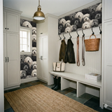 Cumulus Companion Wallpaper with black and white dog pattern, covering the walls of a gray-toned mudroom.