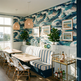 Tidal Force Wallpaper with blue and white ocean wave pattern, covering a wall in a restaurant setting.