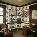 Field March Wallpaper with soldier print, patterned walls, and military memorabilia displayed on shelving.