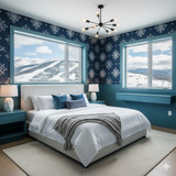 Nordic Hearth wallpaper with blue snowflake pattern, covering a bedroom wall next to snowy mountain views.
